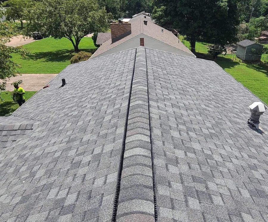 An aerial view of a roof of a house with a gray shingle roof.