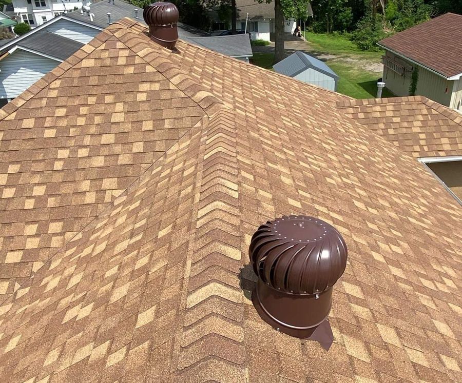 A brown roof with a wind turbine on it