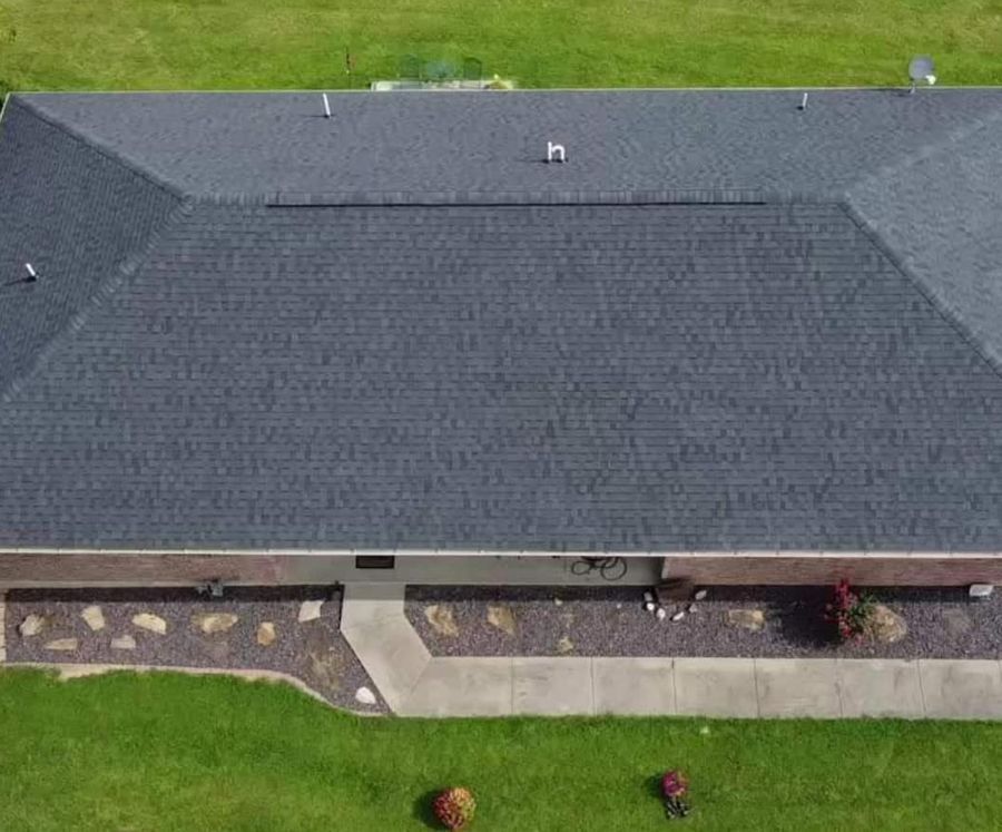 An aerial view of a house with a new roof.