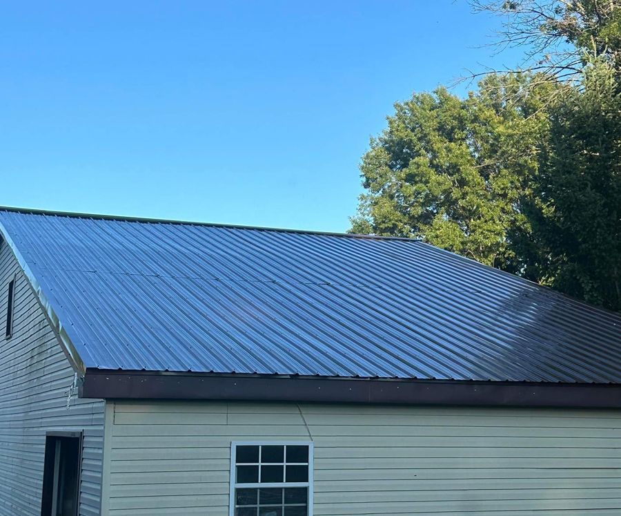 A house with a metal roof and a window