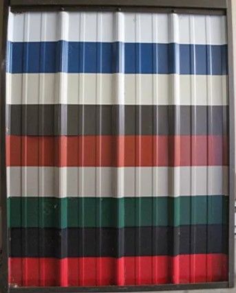 A sample display of corrugated metal roofing sheets arranged vertically in rows of white, blue, cream, brown, red, grey, green, black, and red.