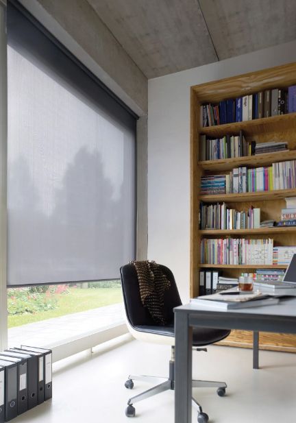 A desk and chair in a room with bookshelves