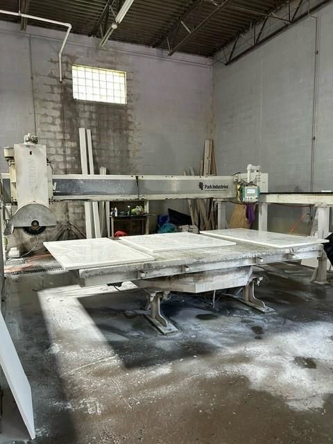 A large industrial stone cutting machine in a workshop