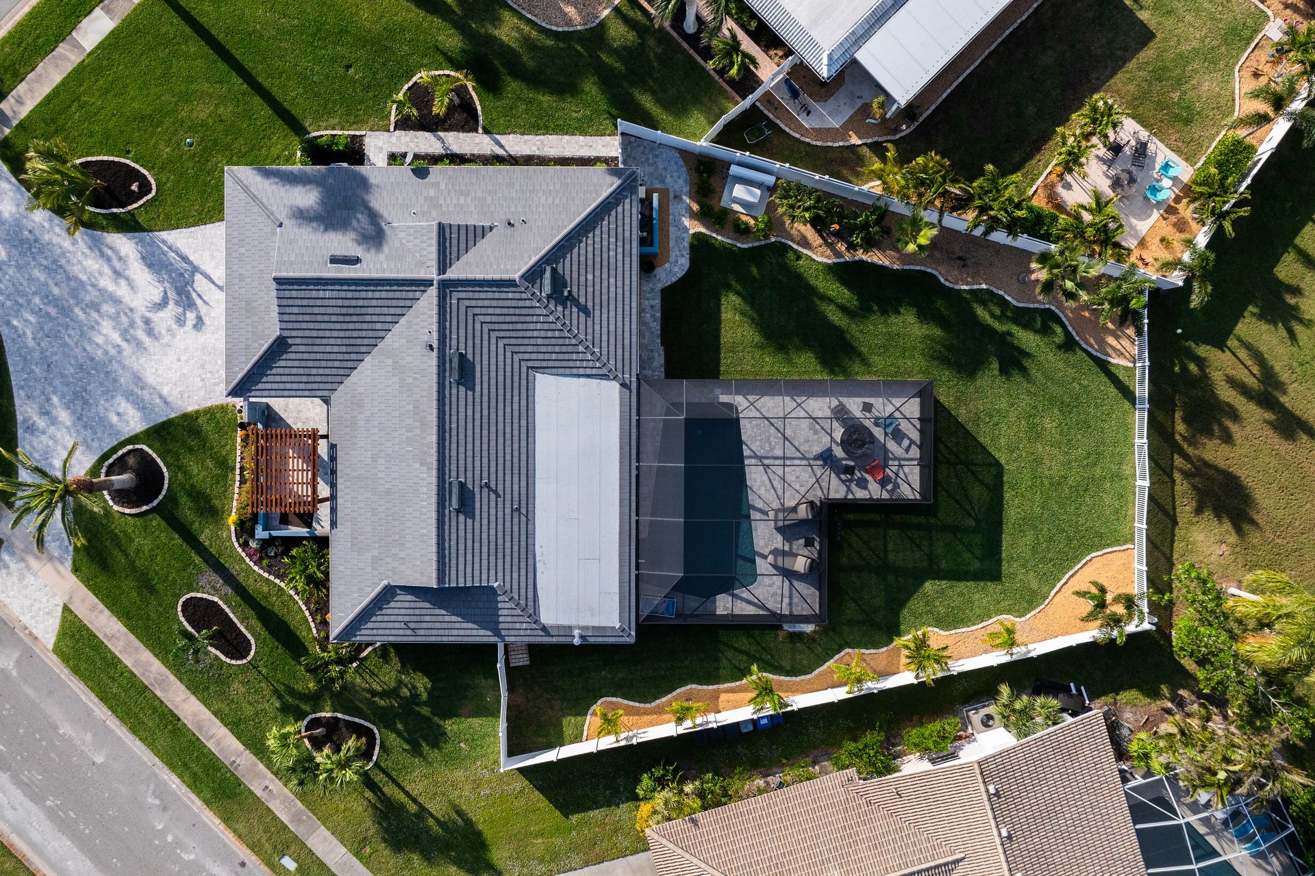 An aerial view of a house with a pool in the backyard