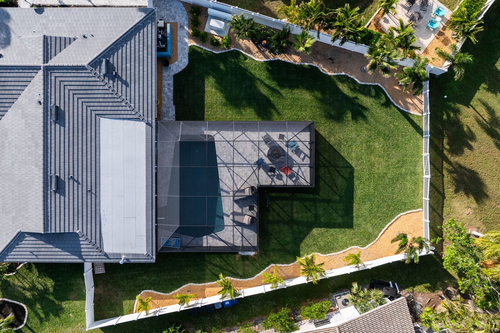 An aerial view of a house with a pool in the backyard.