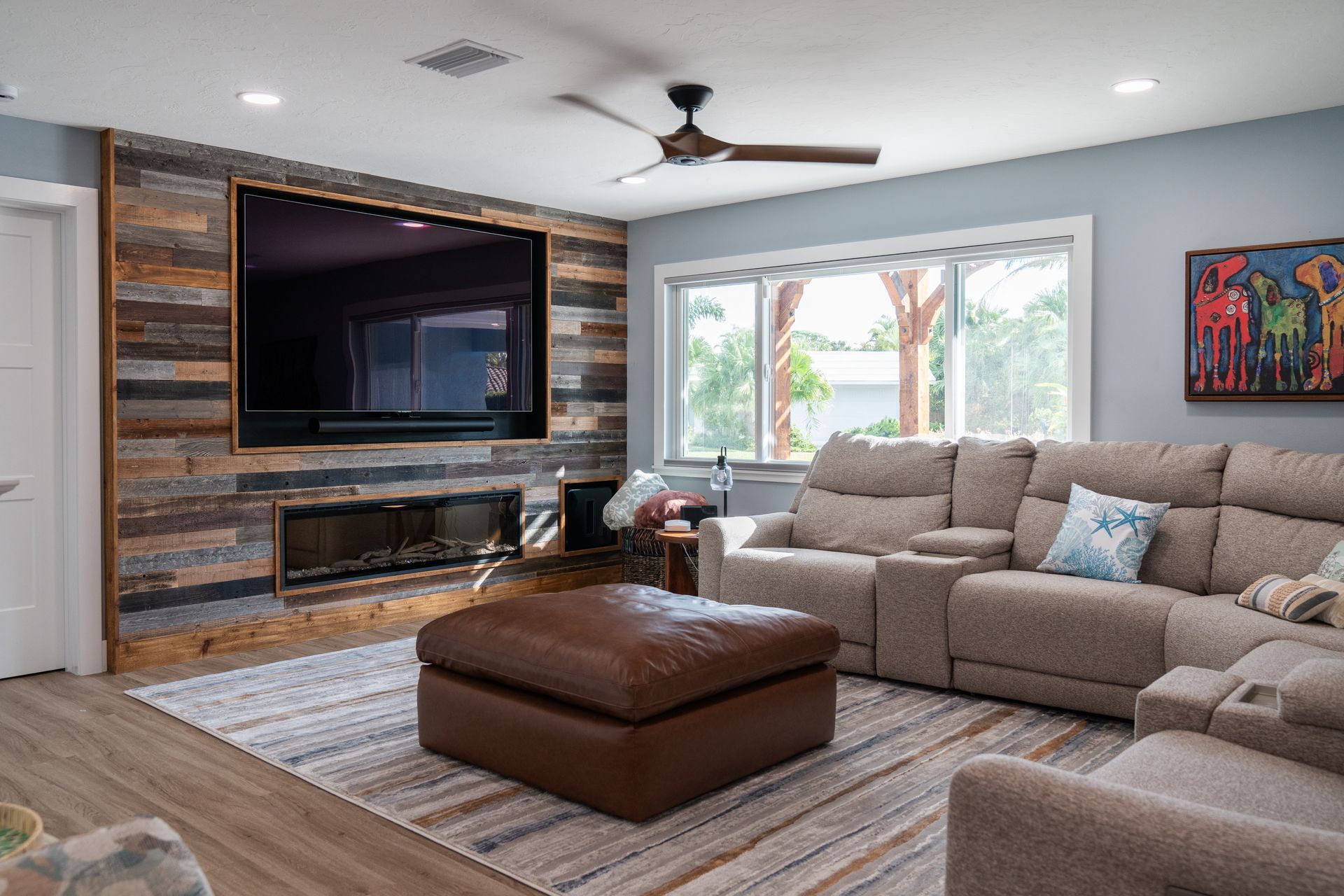 A living room with a large flat screen tv mounted on the wall.