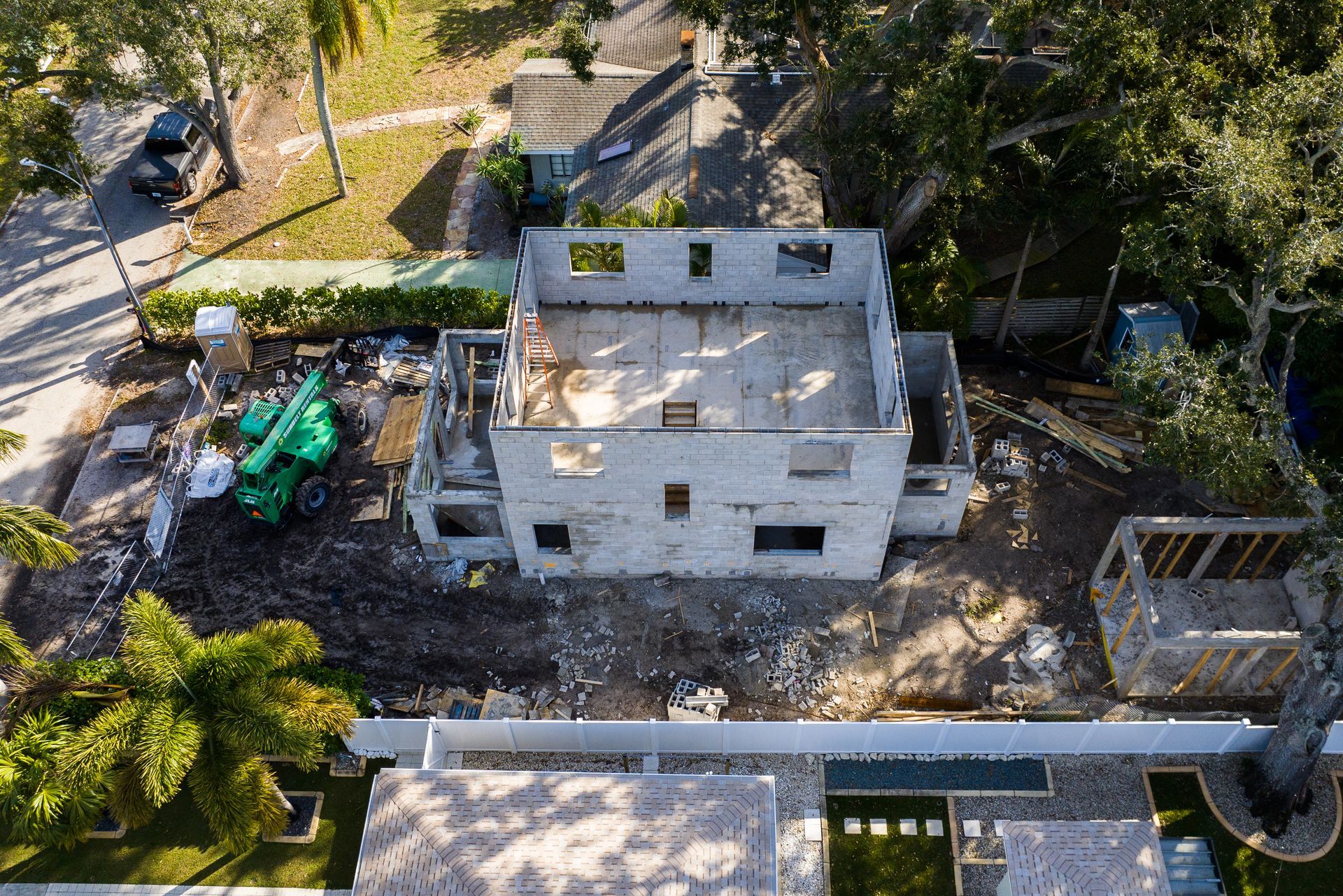 An aerial view of a house under construction in a residential area.