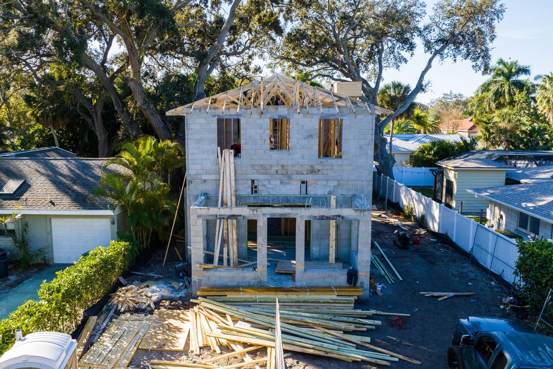 An aerial view of a house under construction in a residential area