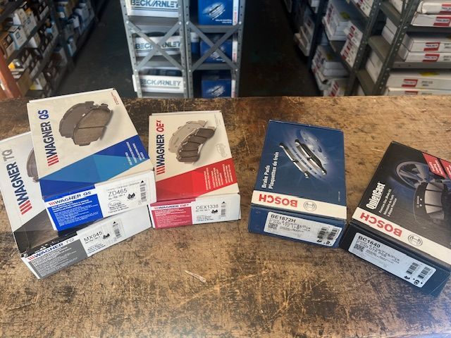 A bunch of brake pads are sitting on a table in a store.