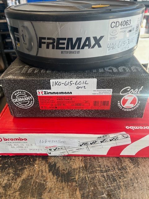 A stack of brake pads sitting on top of each other on a wooden table.