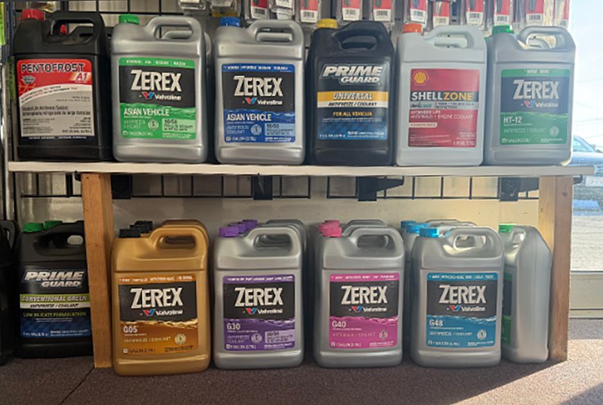 Shelves of automotive coolants in various colors and brands.