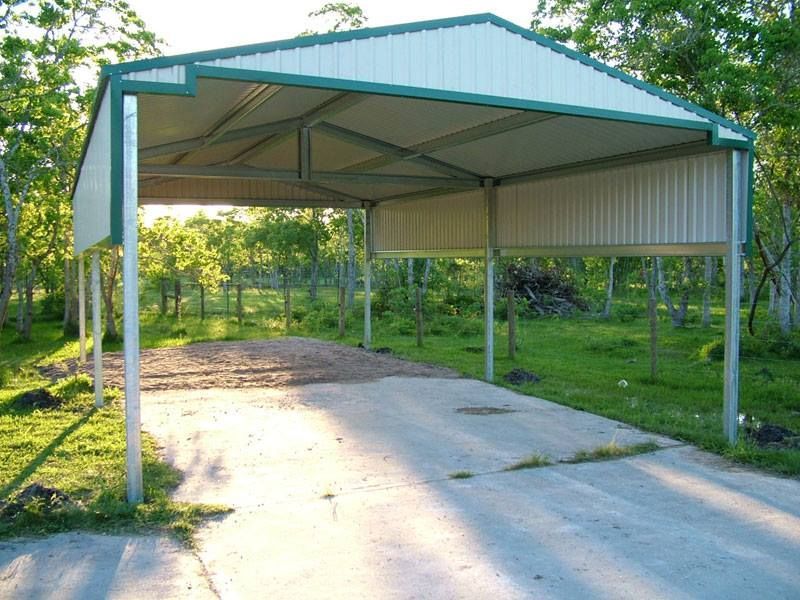 A white and green carport with trees in the background
