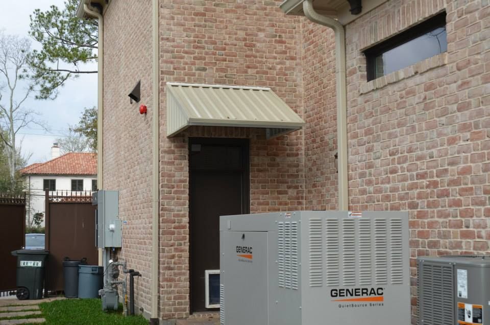 A brick building with a generator on the side of it.