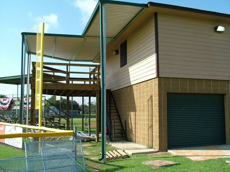 A house with a green garage and stairs leading up to it
