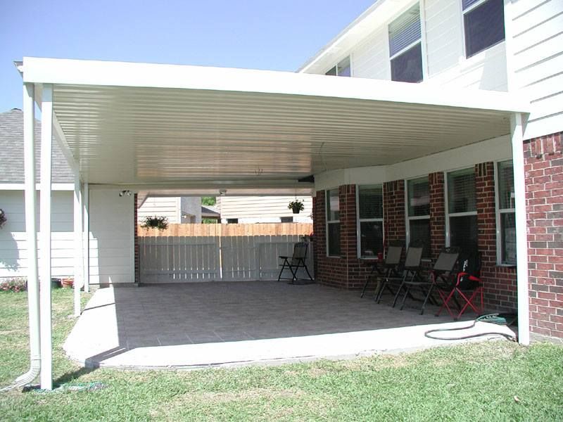A house with a covered patio with chairs underneath it