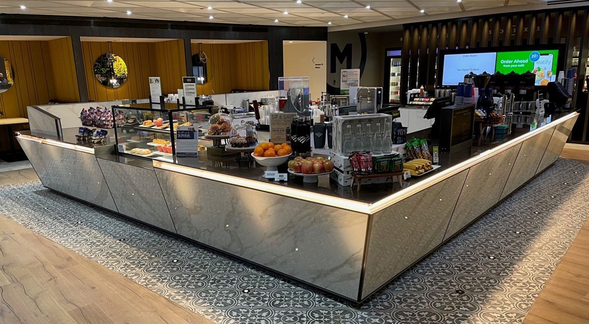 A large counter in a restaurant with a lot of food on it
