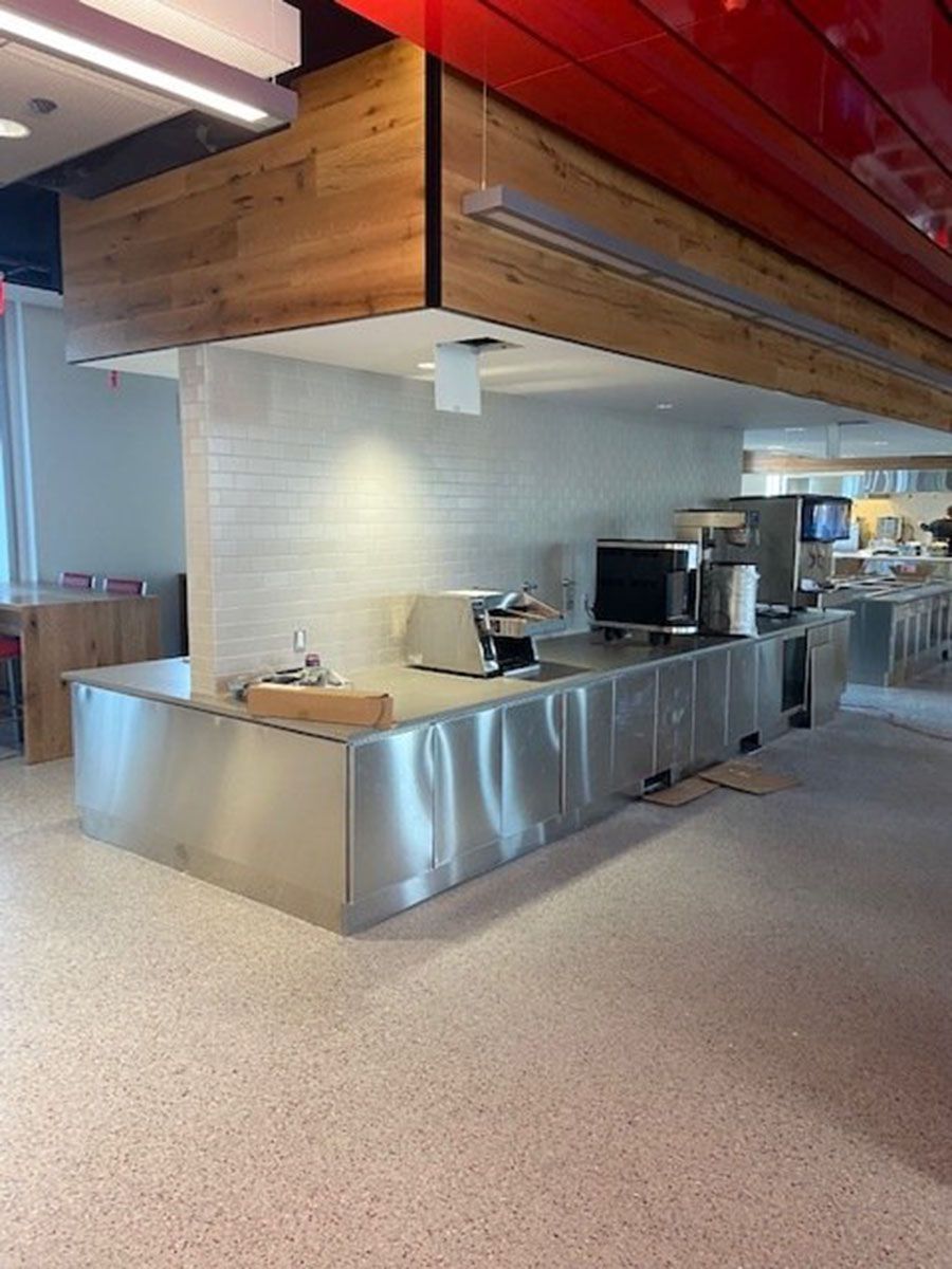 A kitchen with stainless steel countertops and a red ceiling