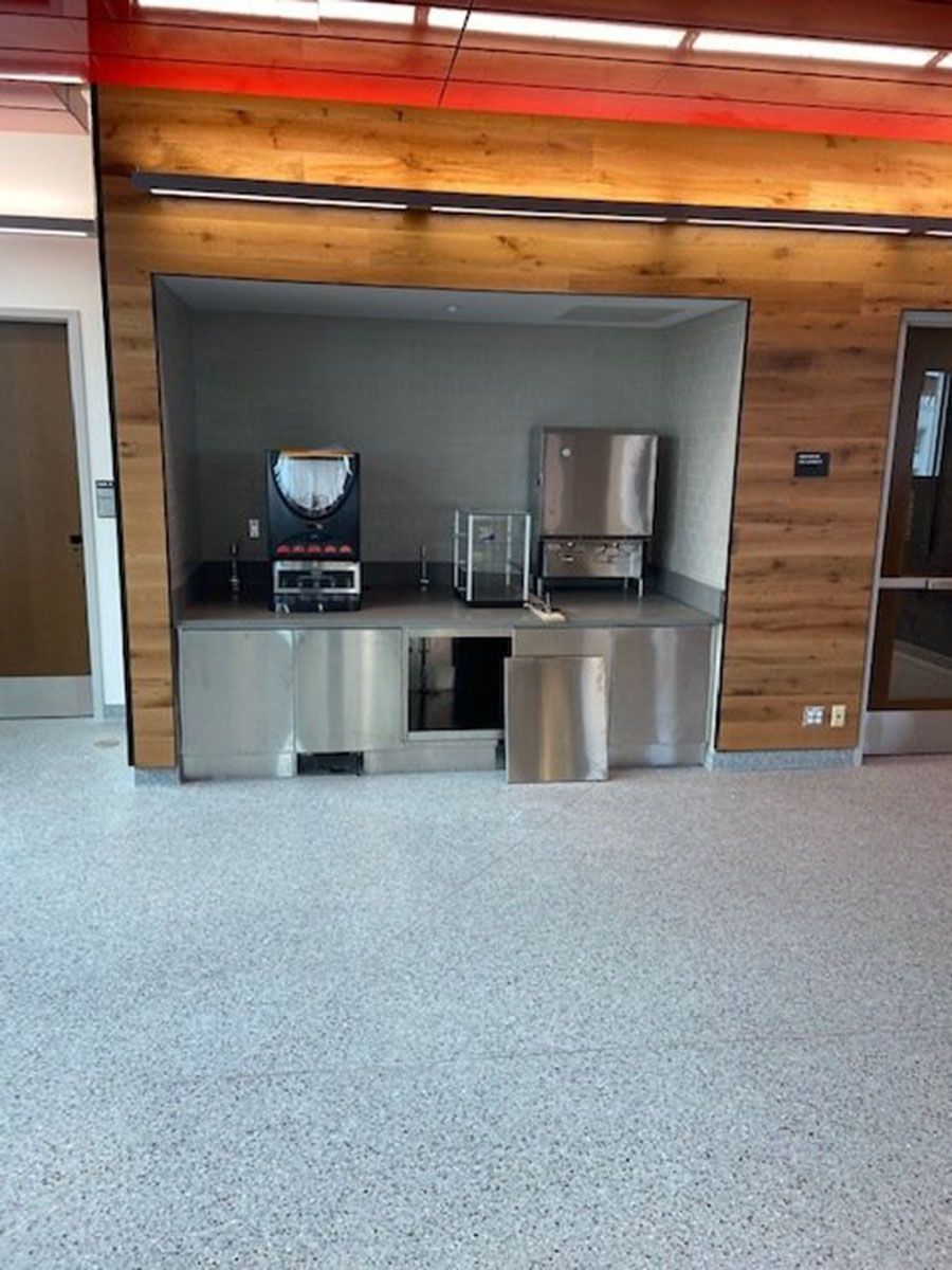 A kitchen with stainless steel cabinets and a coffee maker