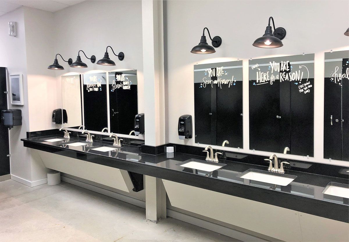 A bathroom with a lot of sinks and mirrors