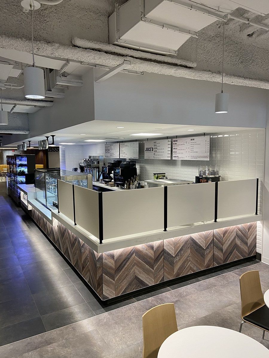 A restaurant with tables and chairs and a long counter