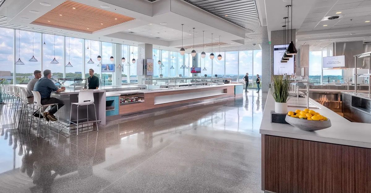 A couple of people are sitting at a table in a restaurant