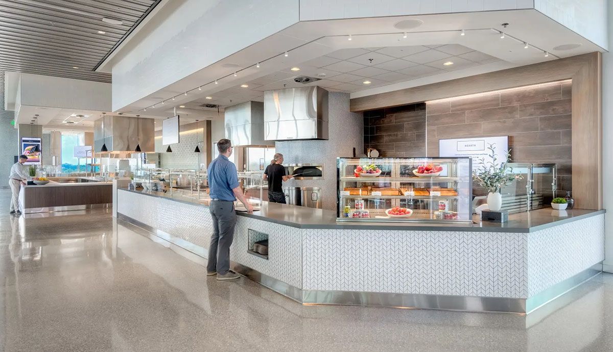 A man is standing at a counter in a restaurant