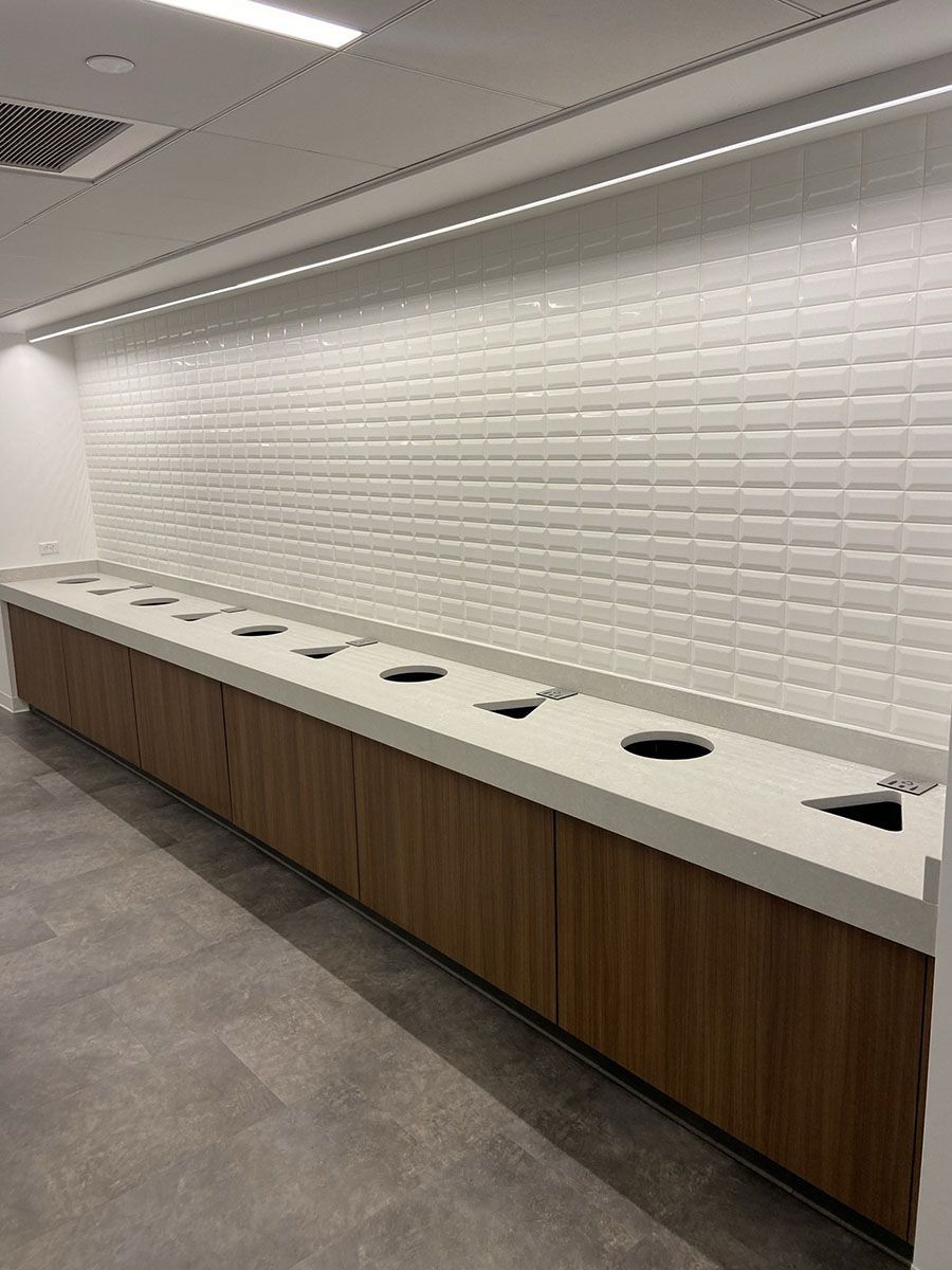 A room with a white tiled wall