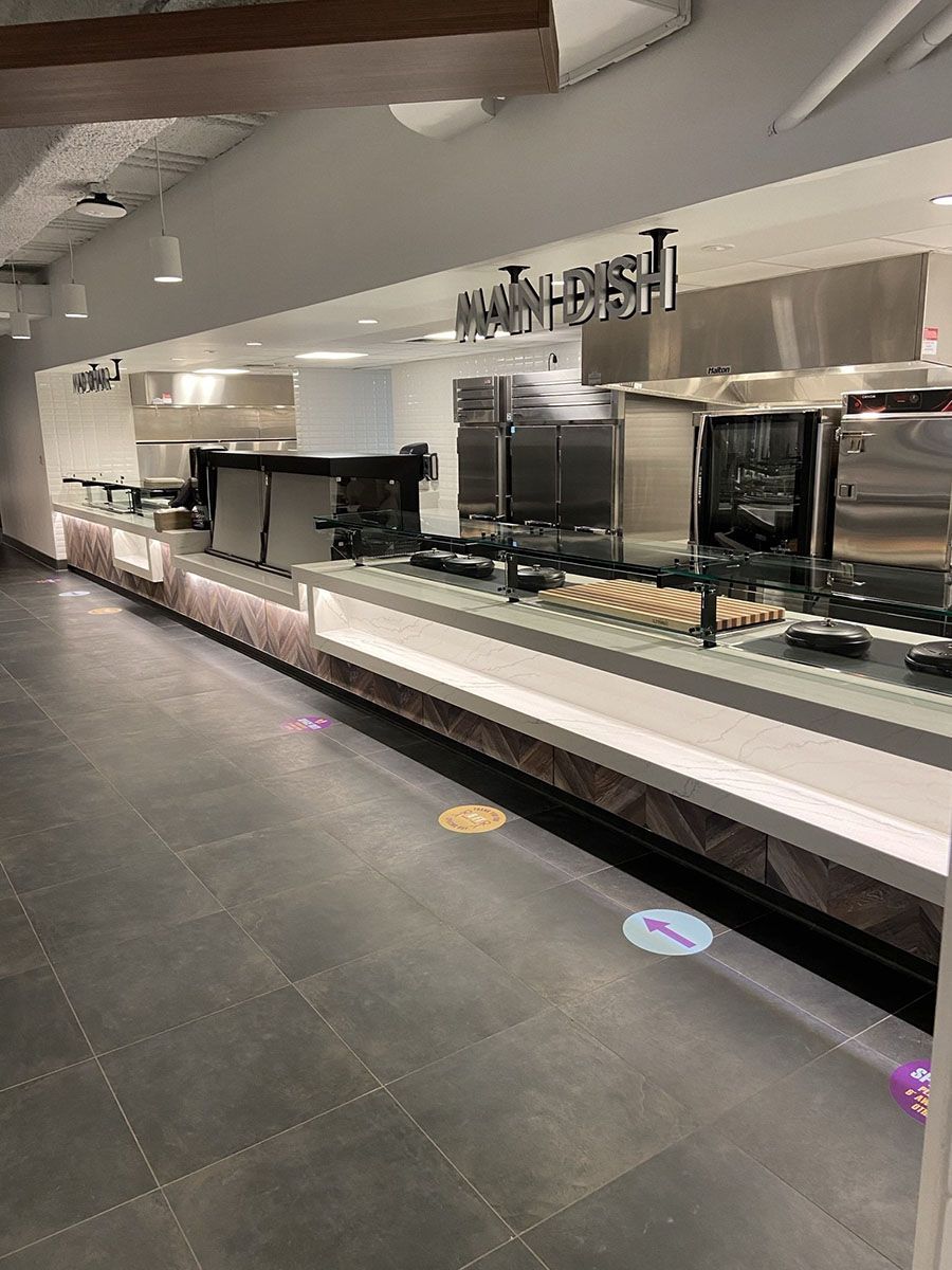 A long buffet line in a restaurant with stainless steel appliances