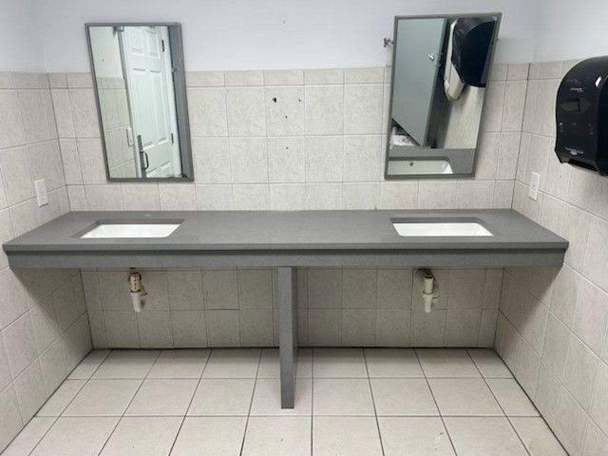 A bathroom with two sinks and two mirrors