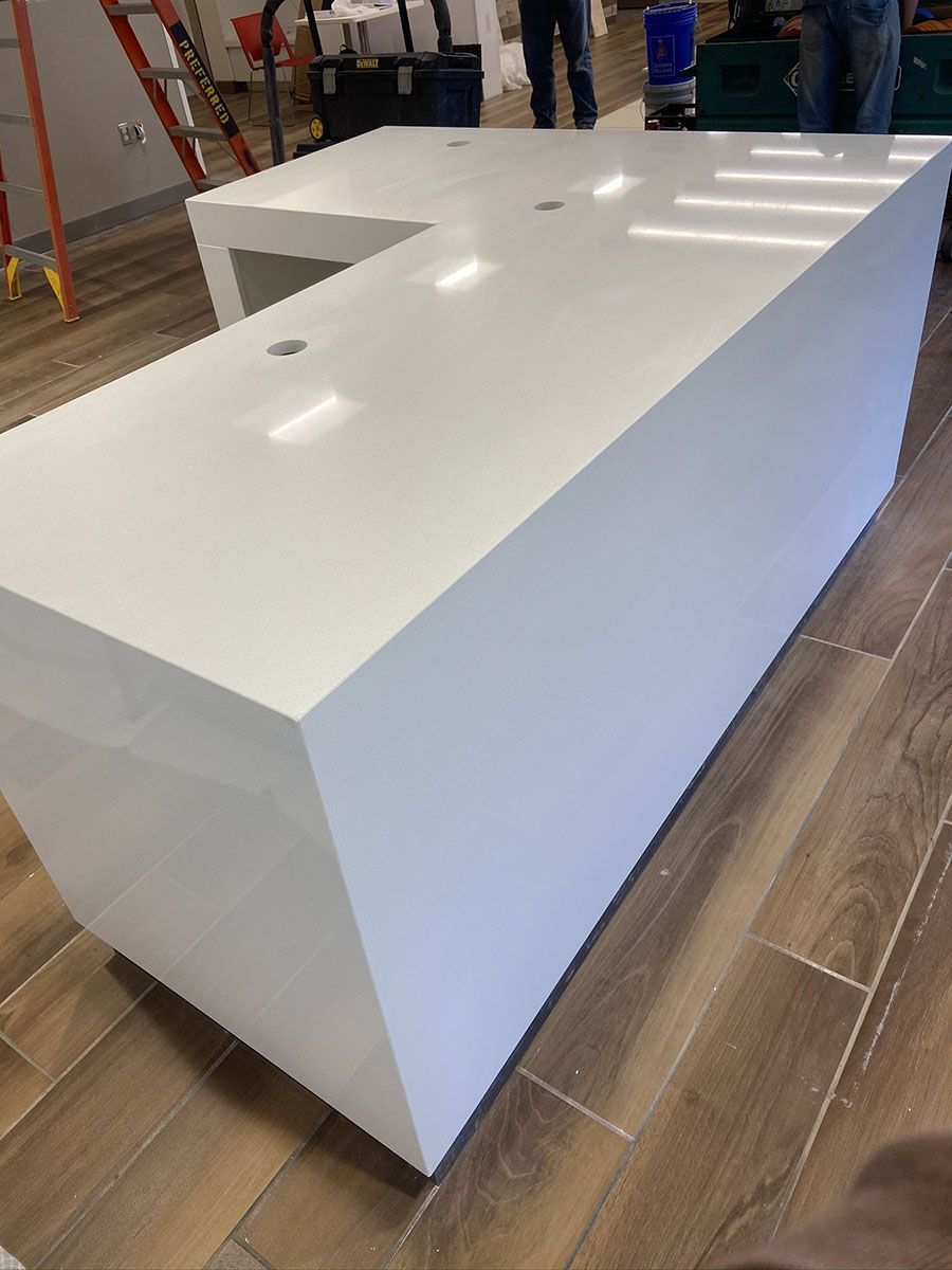 A large white countertop is sitting on a wooden floor in a room
