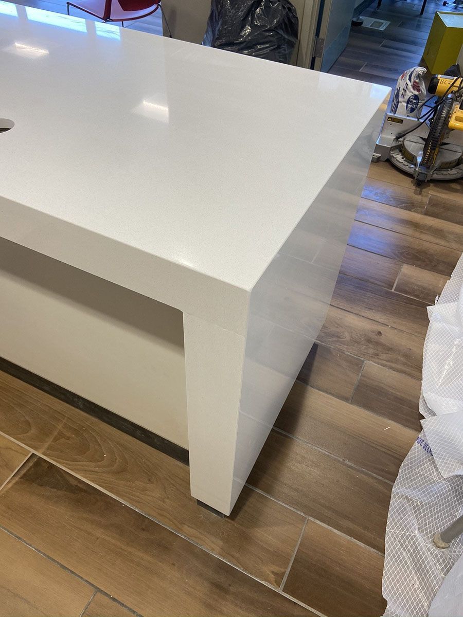 A white table is sitting on a wooden floor in a room