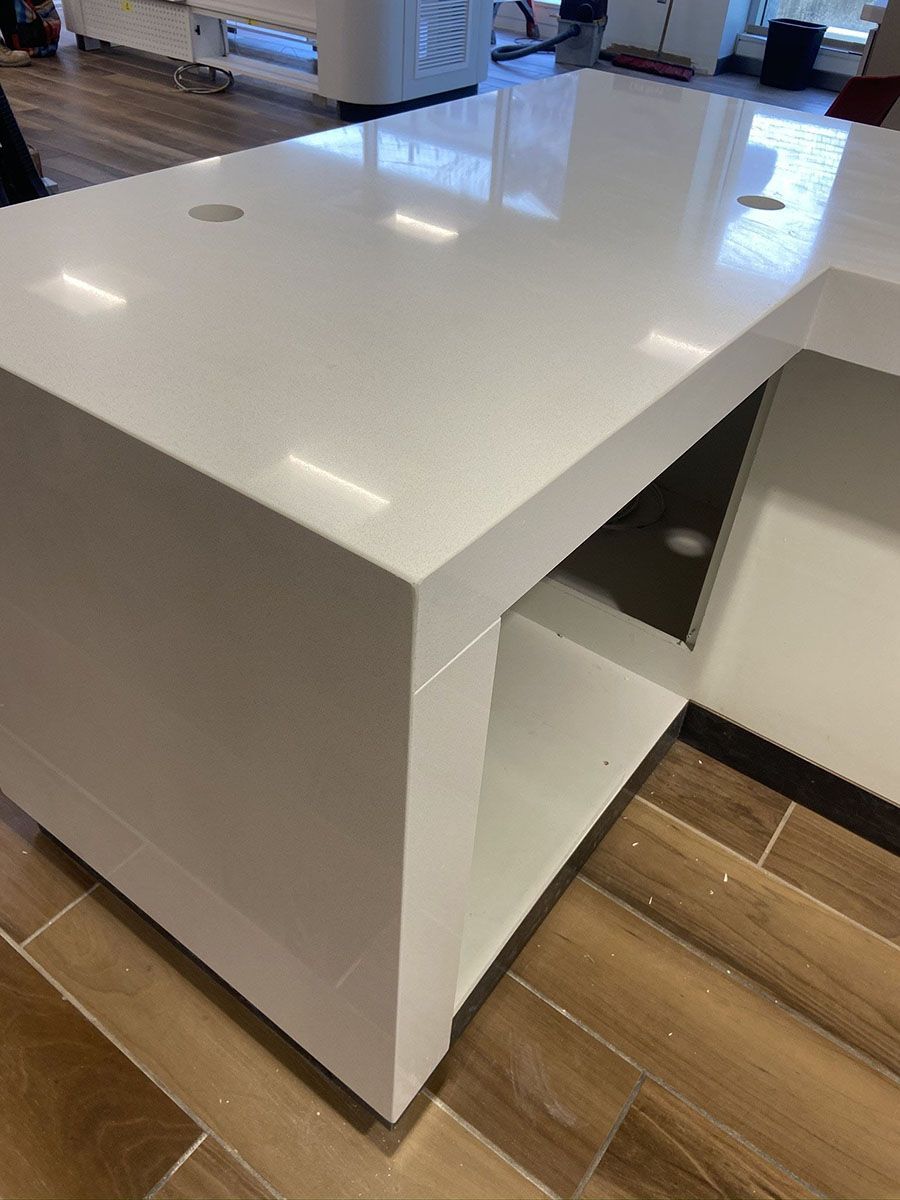 A new white table is sitting on top of a wooden floor