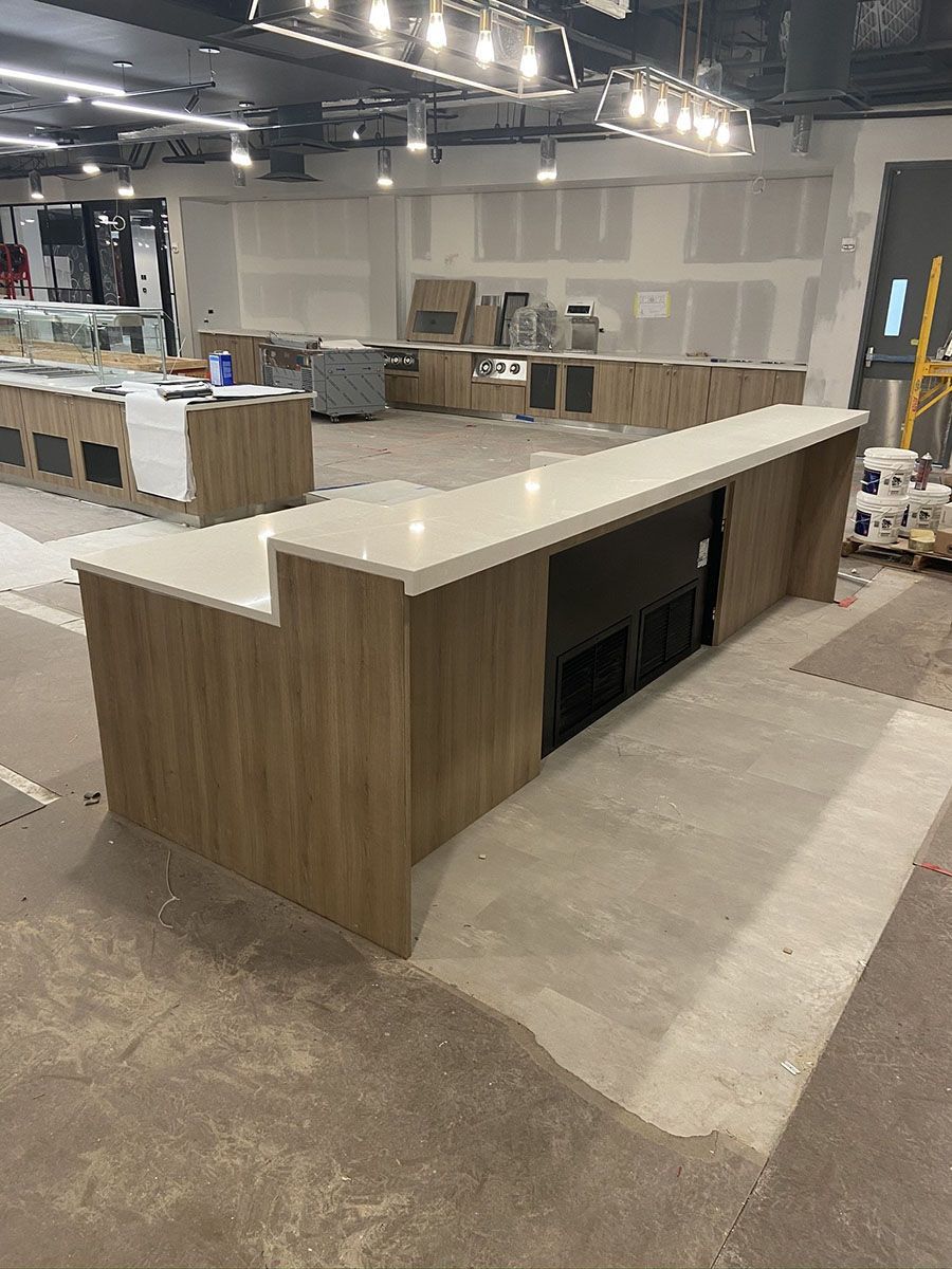 A large room with a long counter in the middle of it