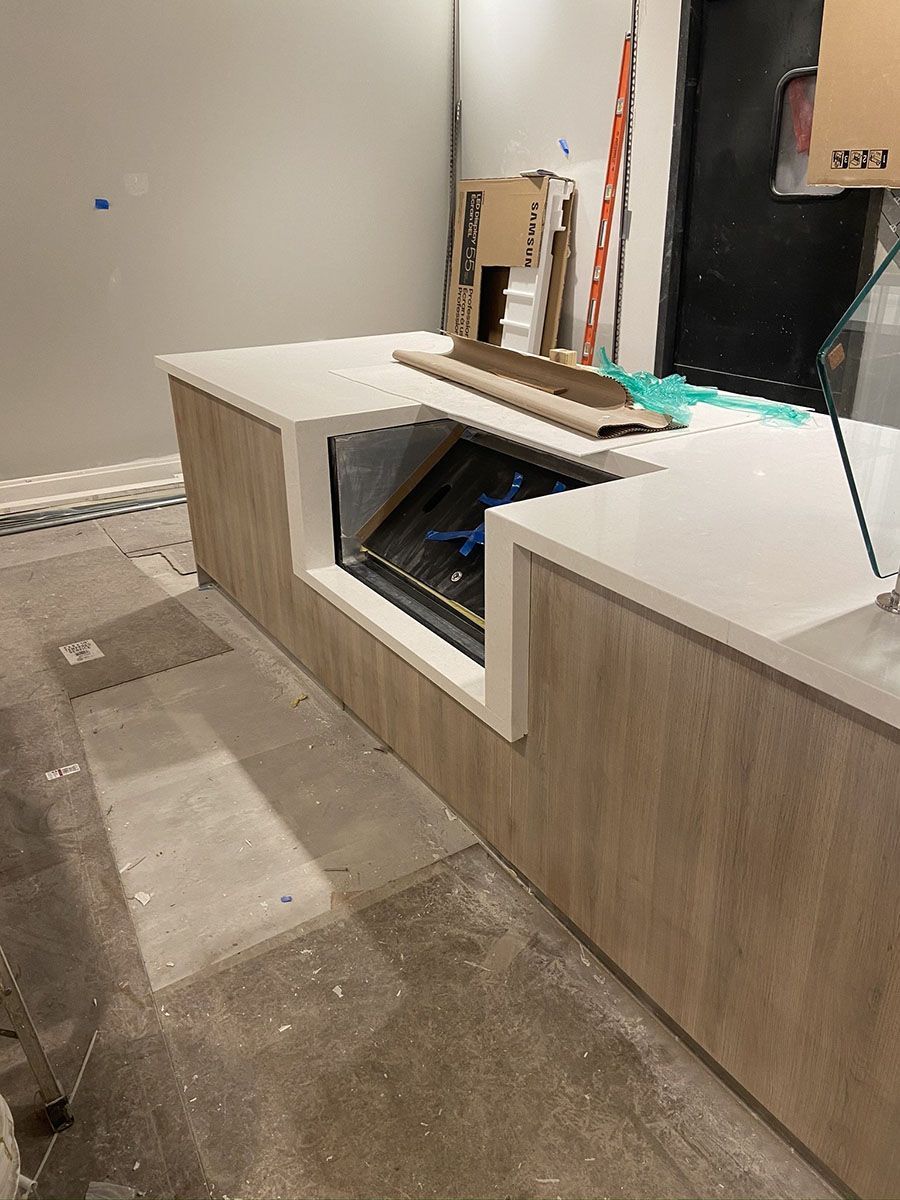 A kitchen counter with white countertop
