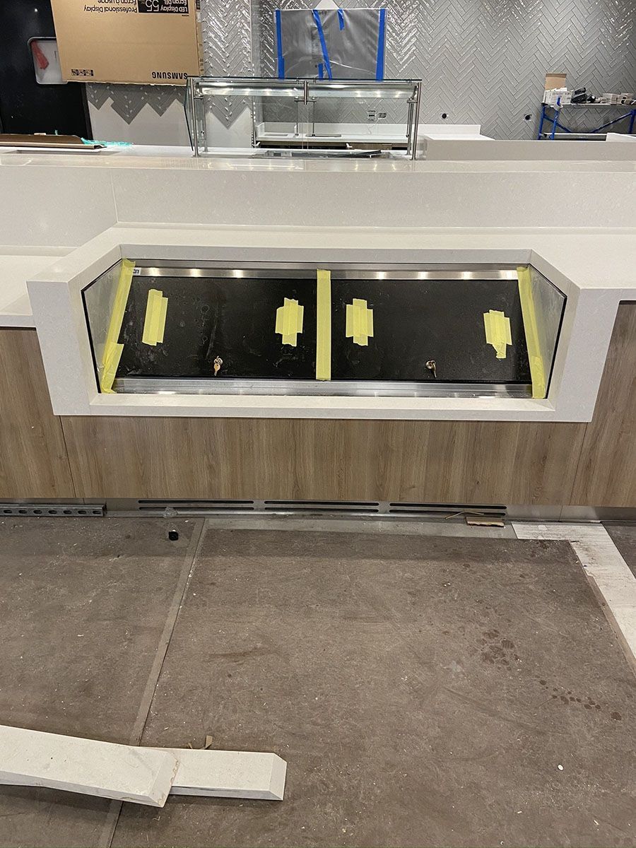 A stainless steel display case is being built in a restaurant