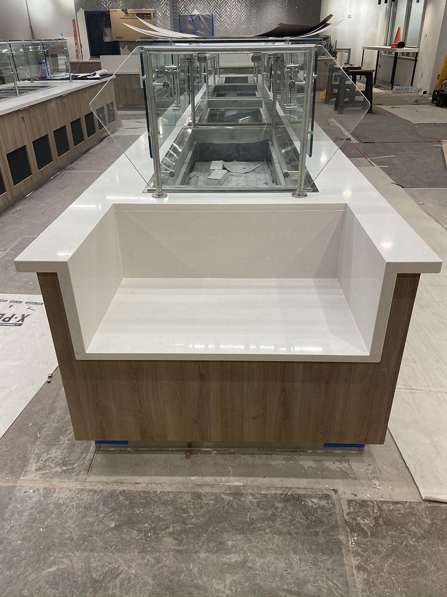 A long buffet line is being built in a restaurant