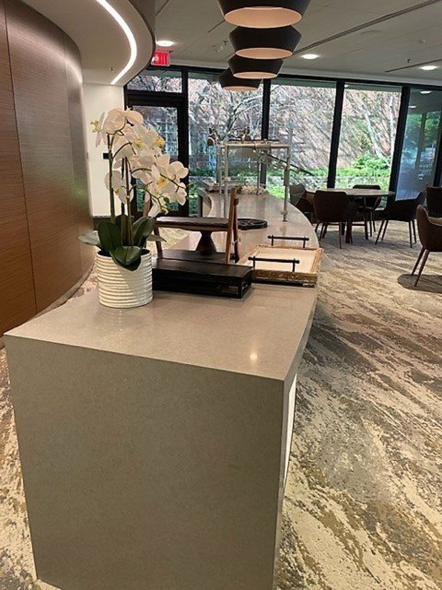 A restaurant counter with flowers on it