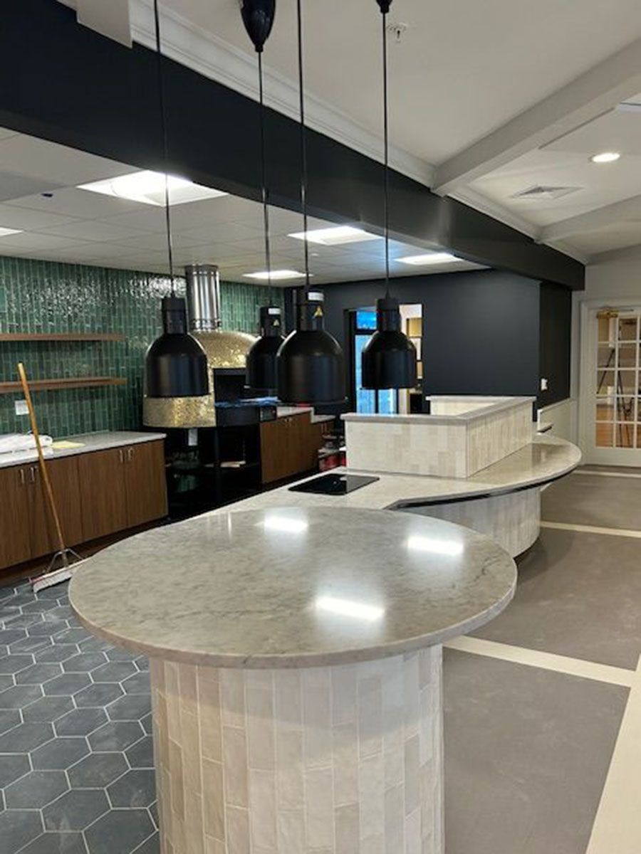 A kitchen with a lot of lamps hanging from the ceiling