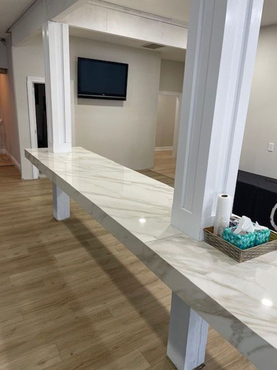 A long counter in a room with a television on the wall