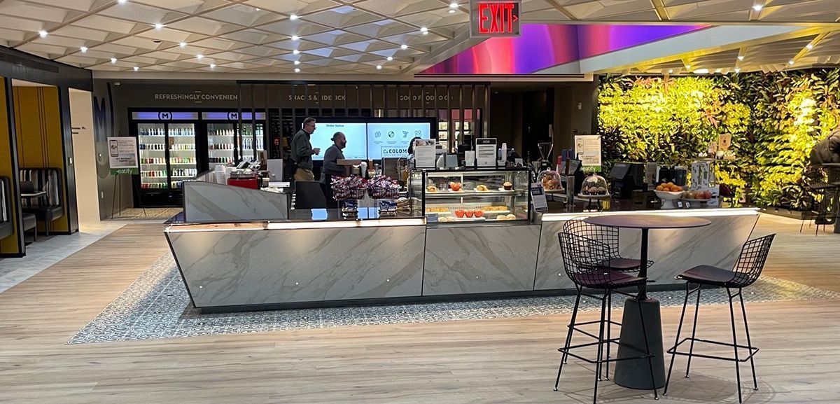 A restaurant with a table and chairs in front of it