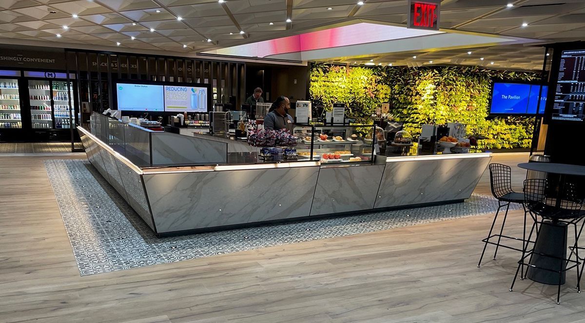 A restaurant with a large counter in the middle of the room