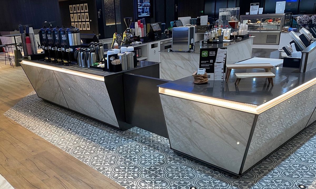 A restaurant with a marble countertop and a wooden floor