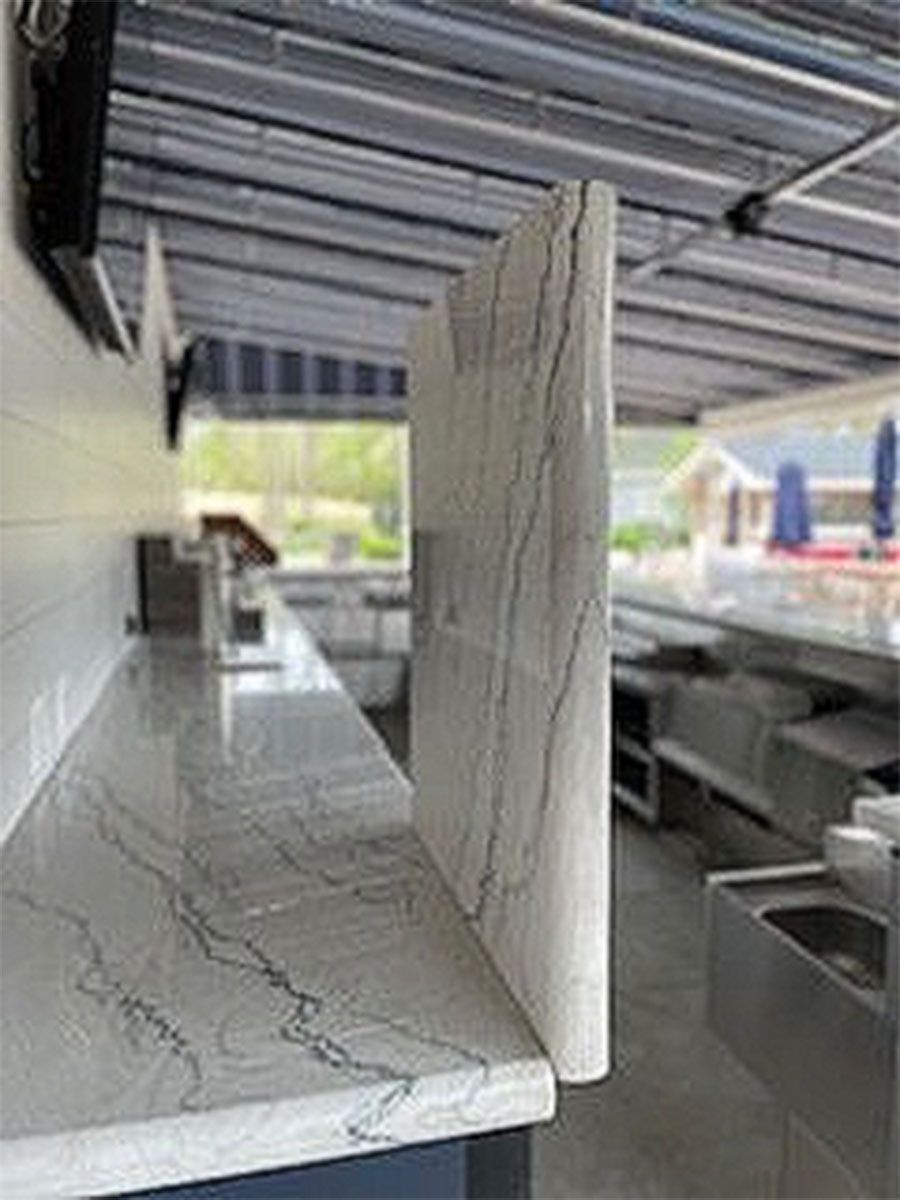 A kitchen with a marble countertop