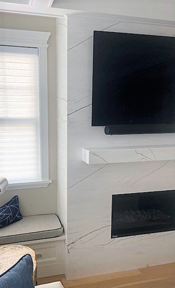 A beautiful living room with a fireplace and a flat-screen TV on the wall