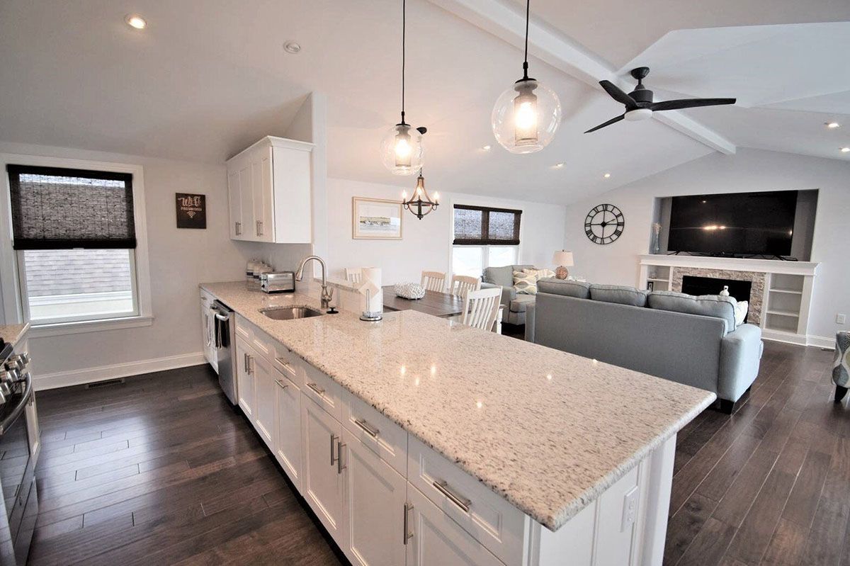 A kitchen with a large island and a ceiling fan