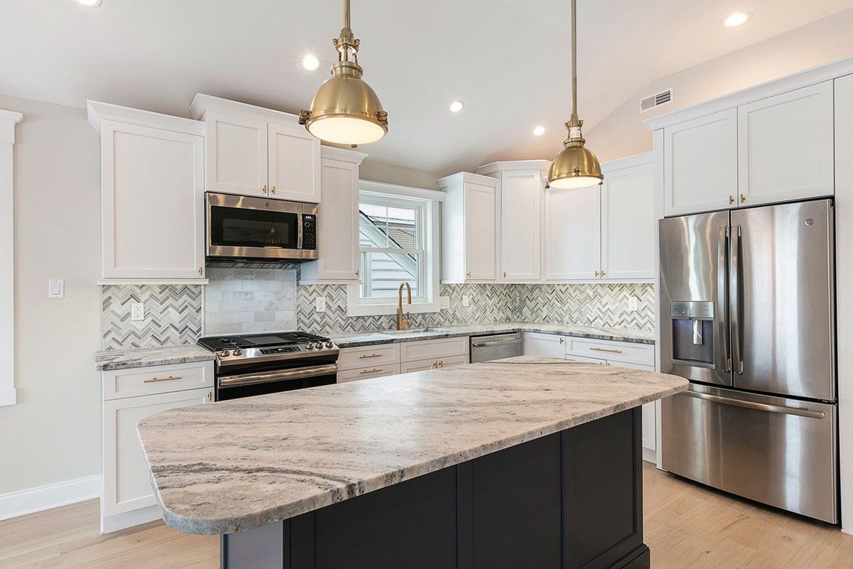 A kitchen with stainless steel appliances and granite countertops