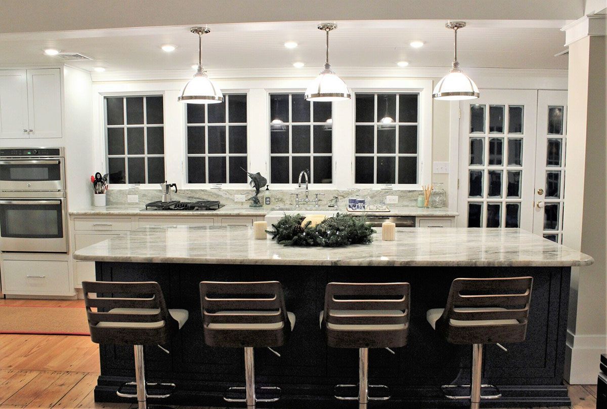 A kitchen with a large island and stools