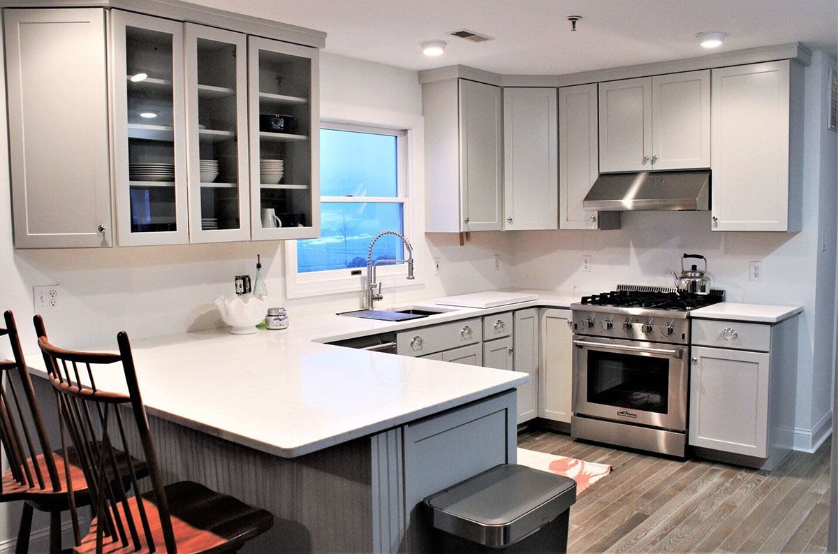 A kitchen with white cabinets and stainless steel appliances