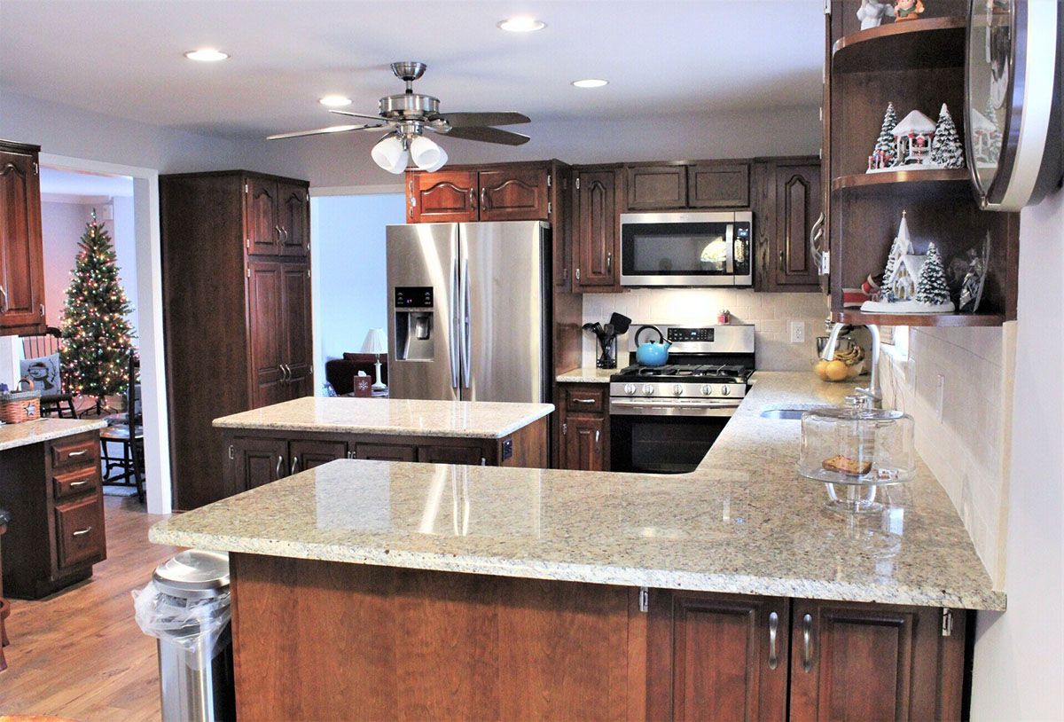 A kitchen with stainless steel appliances and granite countertops