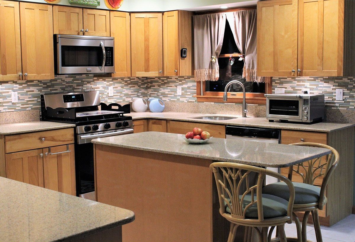 A kitchen with stainless steel appliances and wooden cabinets